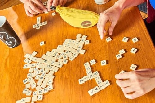 Bananagrams Classic Word Game – Fast-Paced Spelling & Anagram, Family & Travel Game , 144 Letter Tiles in Portable Banana Pouch, 1–8 Players, Educational Wordplay Fun for Ages 7+