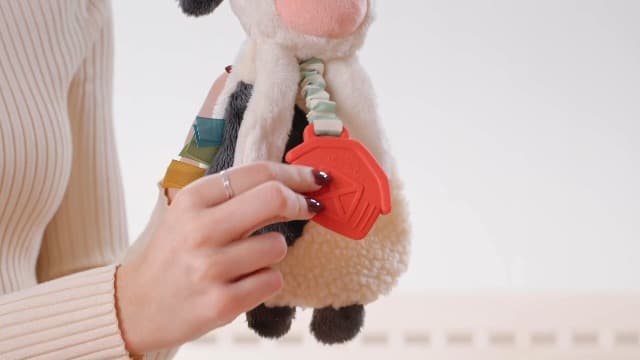 Baby Lovey With Soft Sherpa, Plush Minky, Silicone Teether, Crinkle Sounds, Textured Ribbons, and Interactive Dangle Arms Itzy Ritzy Lovey Including Teether, Teething Relief, 0 Months & Up (Cow) B0CQRVXT68