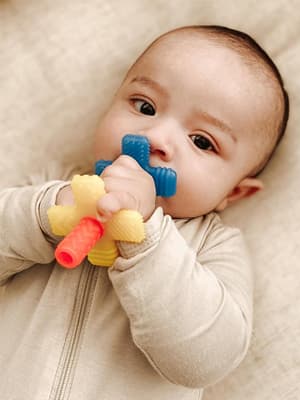 Itzy Ritzy Teensy Tube Teether – Textured Hollow Baby Teething Tube That Reaches Front Teeth & Back Molars, Made of Soft Silicone (Pink Rainbow)